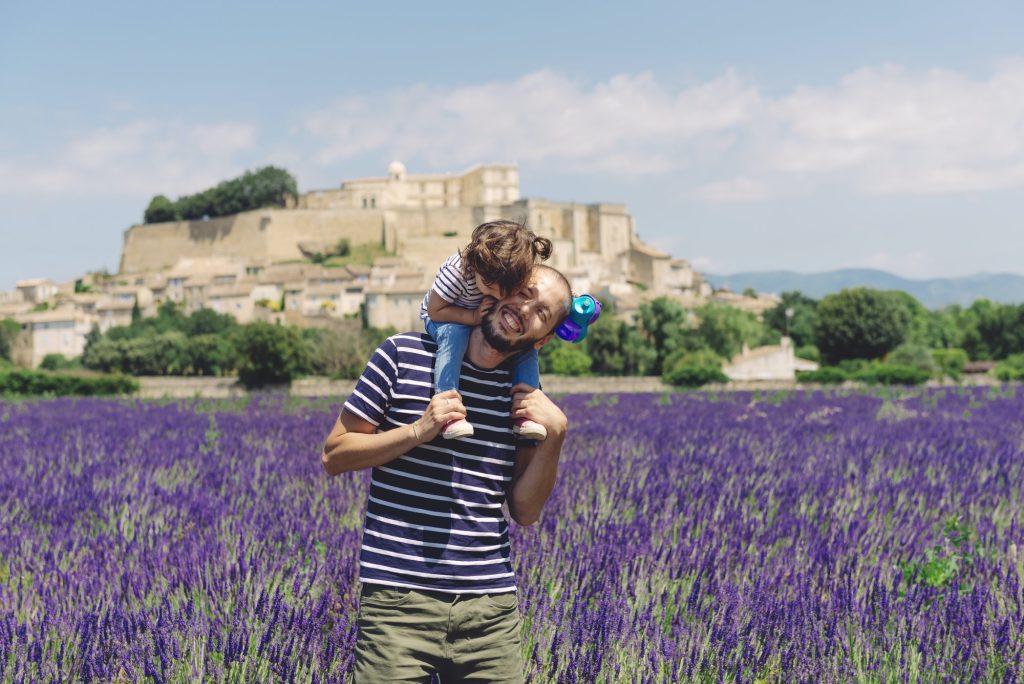 France, Grignan, father and little daughter having fun together in lavender field